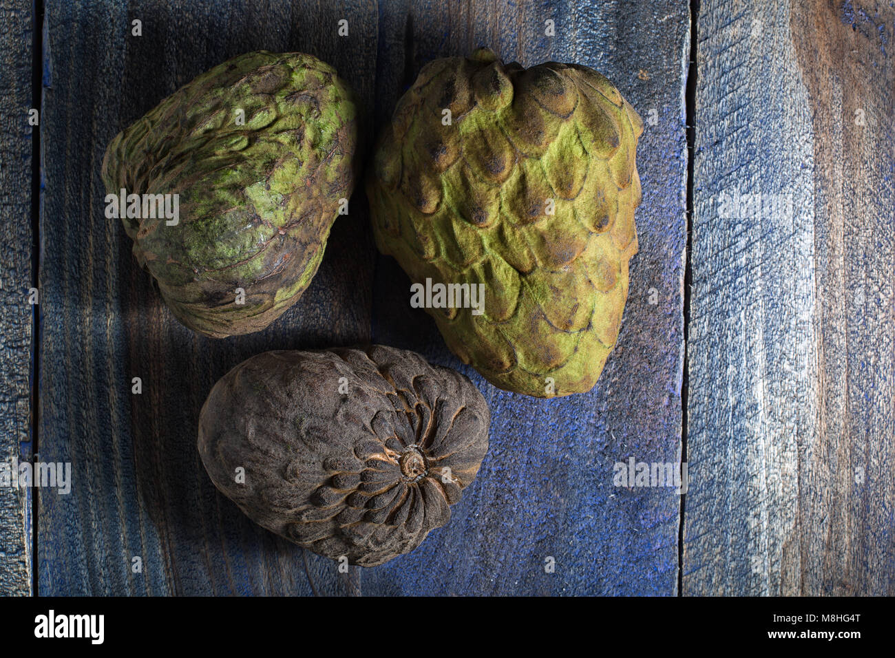 cherimoya fruits also known as custard apple on rustic background Stock Photo