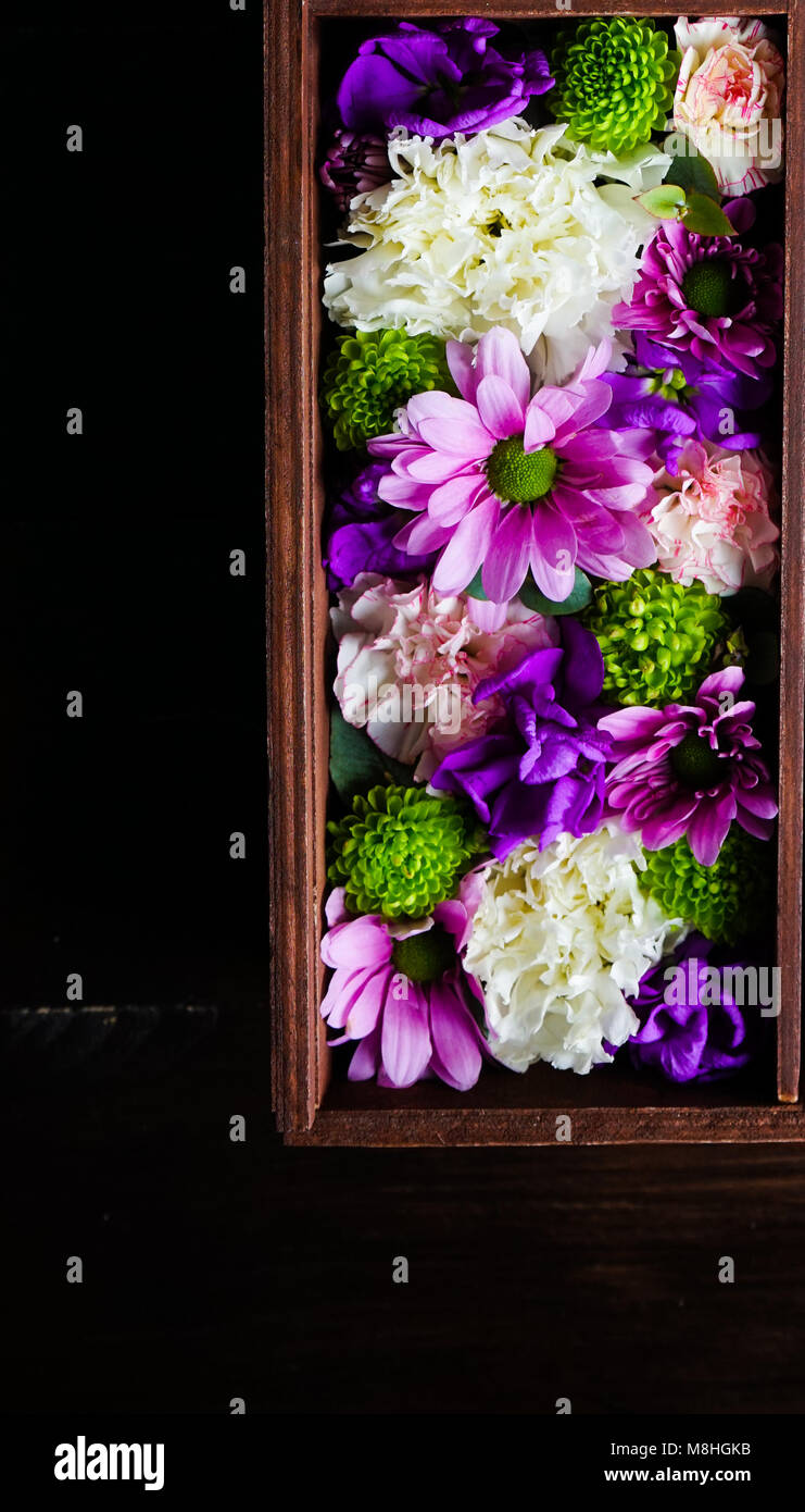Creative card concept with beautiful flowers on wooden background with copyspace Stock Photo