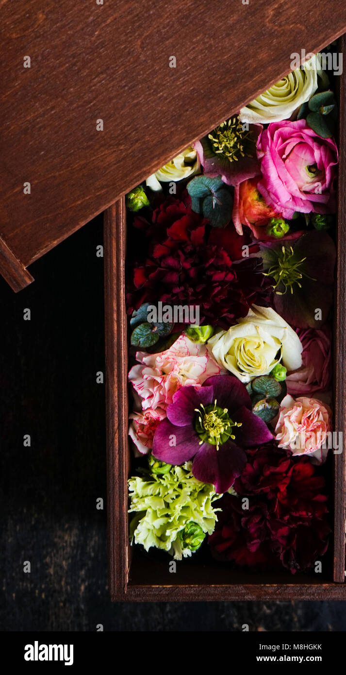 Creative card concept with beautiful flowers on wooden background with copyspace Stock Photo