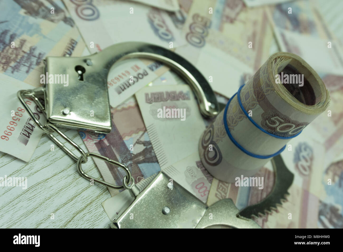 Bribe money and handcuffs violator maffia prison Stock Photo