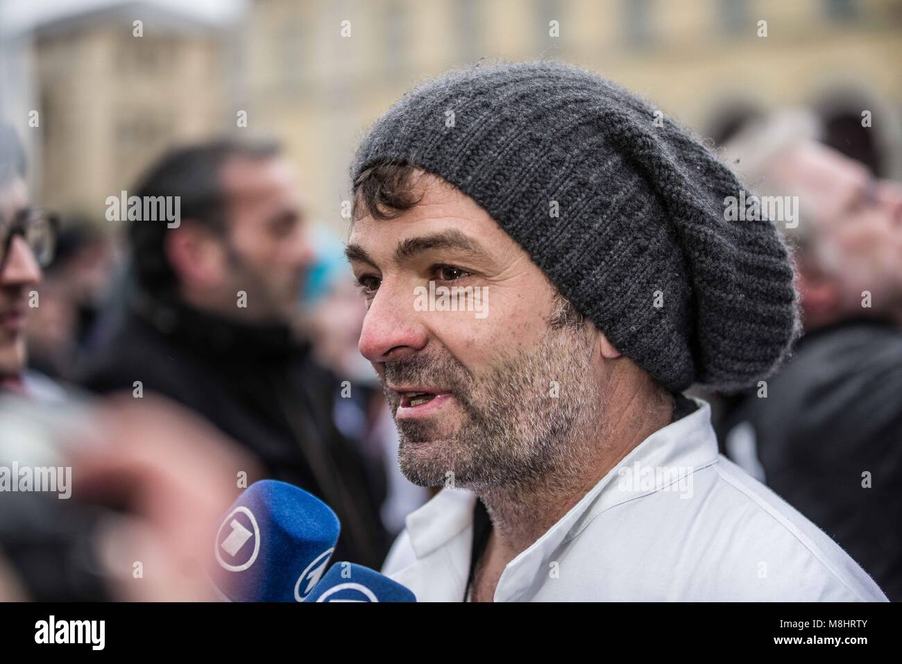 Munich, Bavaria, Germany. 17th Mar, 2018. Protesting against the arrival of Pegida Dresden's Lutz Bachmann and Sigfried Daebritz in Munich, no less than three demonstrations were organized by the city, including a Muenchen ist Bunt and Bellevue di Monaco protest at Max Joseph Platz. At this demonstration, choirs were in attendance, along with celebrities, politicians, and other prominent Muenchners dressed as doctors in order to tell Pegida that they will help them go back to Dresden. Participants: Syrischer Friedenschor, MÃ¼nchner Kneipenchor, Der Chor der Schlausschule, KÃ¶sk Chor, Cho Stock Photo