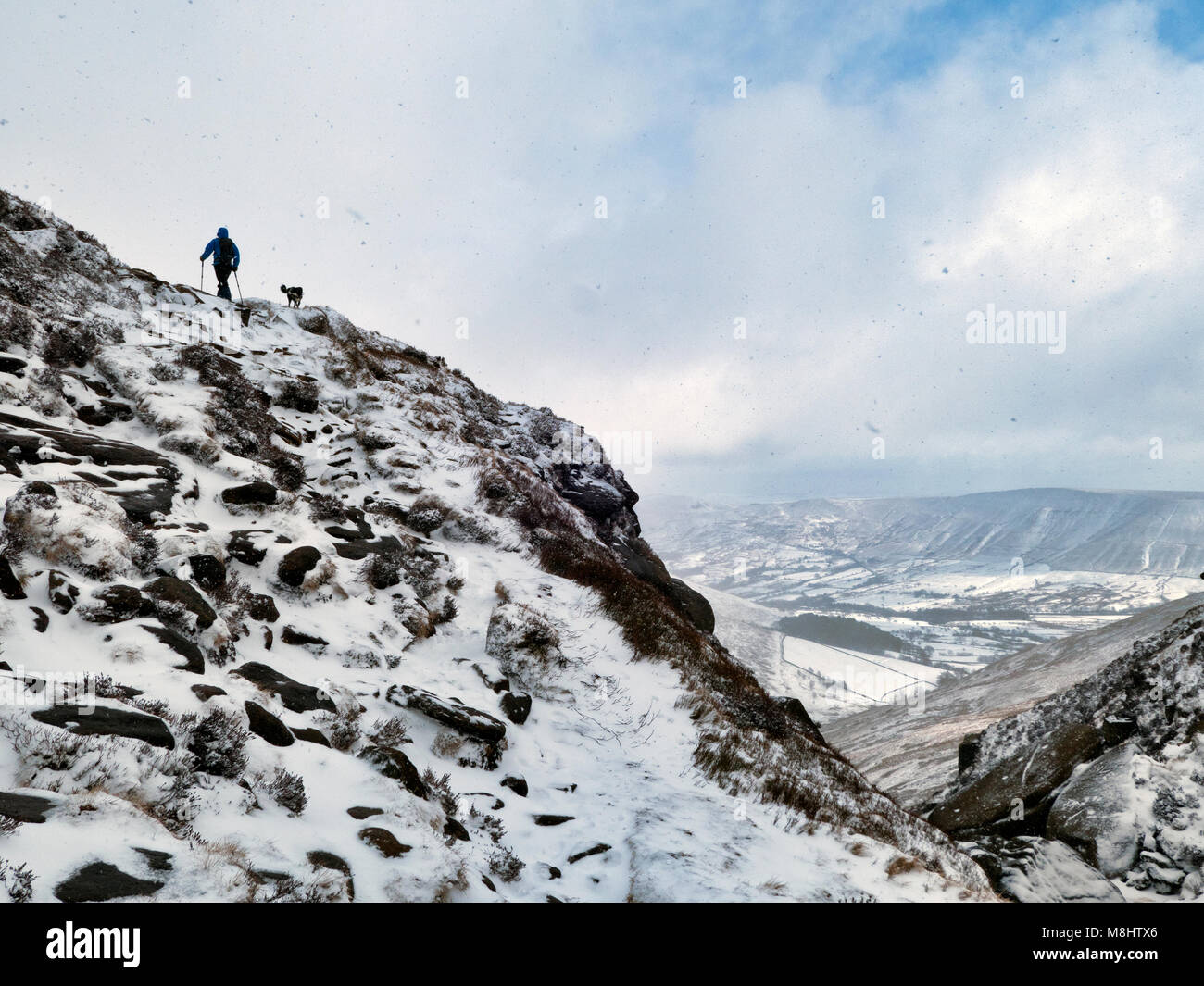 Derbyshire, UK. 17th March 2018 man walking in the Beast From The East 2 snow & Ice conditions with a Border Collie dog around Kinder Scout & Edale in the Peak District National Park, Derbyshire, England, UK Credit: Doug Blane/Alamy Live News Stock Photo
