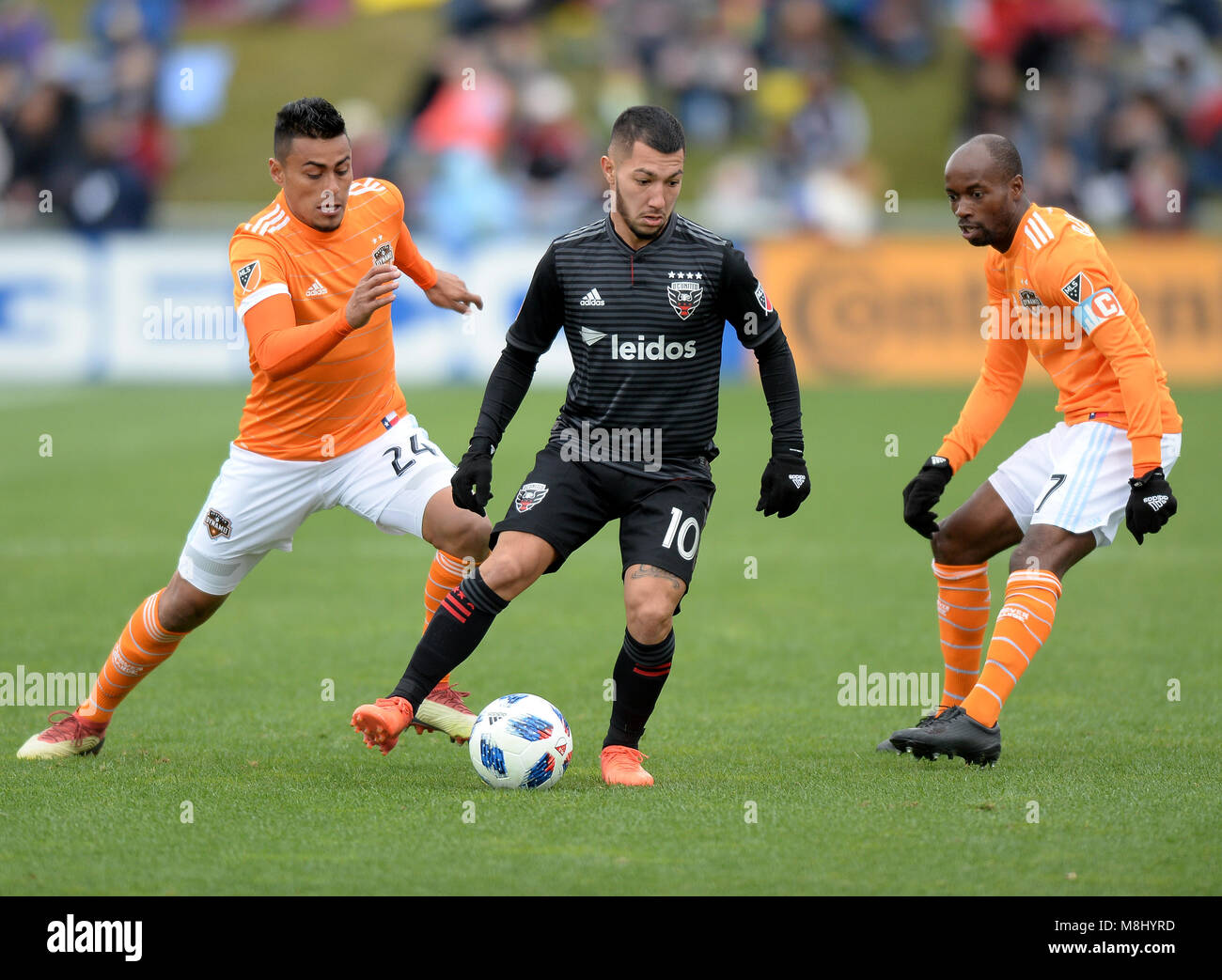 Washington, DC, USA. 17th Mar, 2018. 20180317 - D.C. United midfielder LUCIANO ACOSTA (10) dribbles against Houston Dynamo defender DAMARCUS BEASLEY (7) and Houston Dynamo midfielder DARWIN CEREN (24) in the first half at the Maryland SoccerPlex in Boyds, Md. Credit: Chuck Myers/ZUMA Wire/Alamy Live News Stock Photo