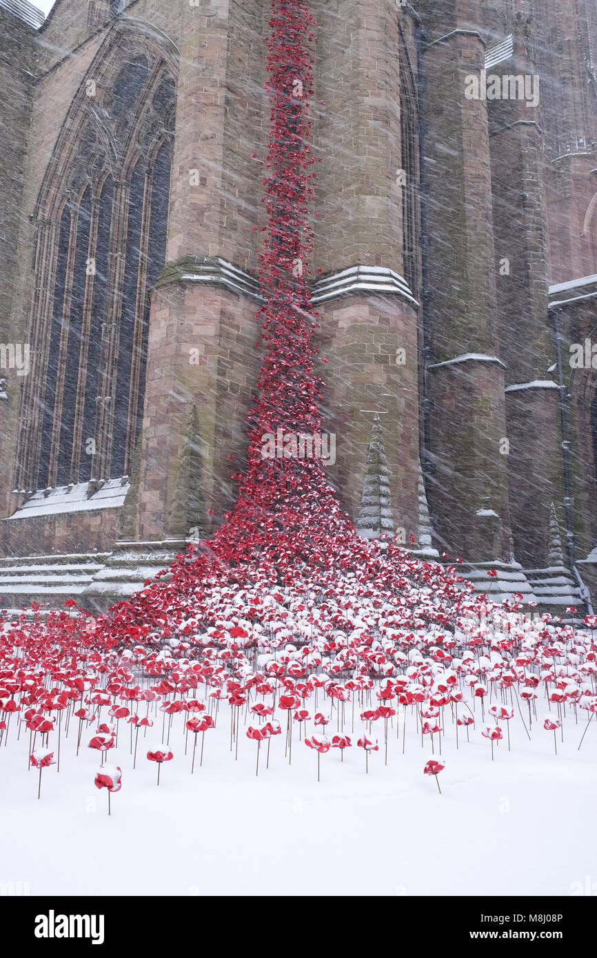 Hereford, Herefordshire, UK - Sunday 18th March 2018 - Hereford Cathedral heavy snowfall overnight continues during Sunday morning  - snow falls on the Weeping Windows ceramic poppy art installation by artist Paul Cummins that commemorates the centenary of WW1 - Steven May /Alamy Live News Stock Photo