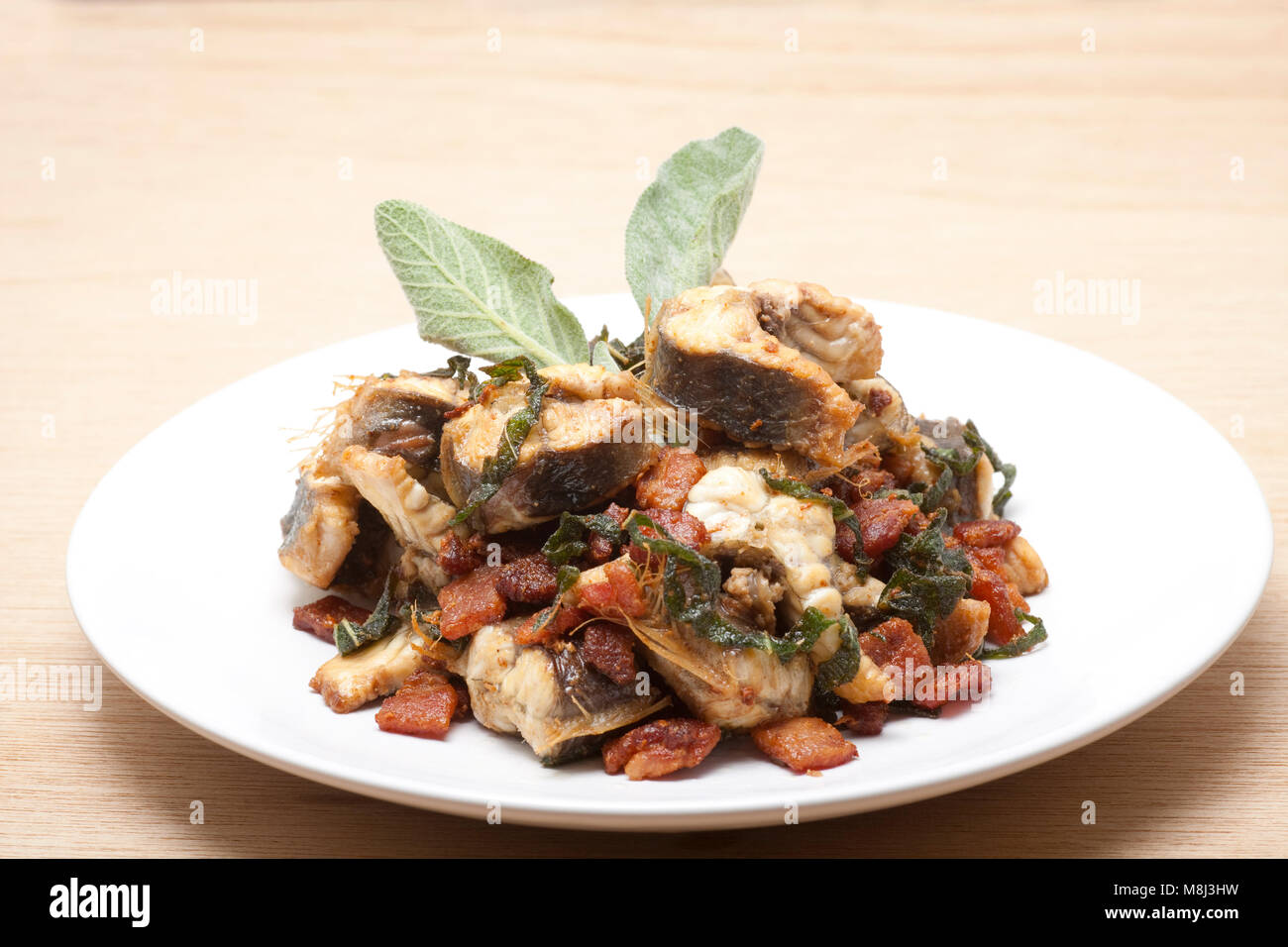 Home Cooked Freshwater Eel Anguilla Anguilla That Has Been Fried With Smoky Bacon And Fresh Sage England Uk Gb Stock Photo Alamy