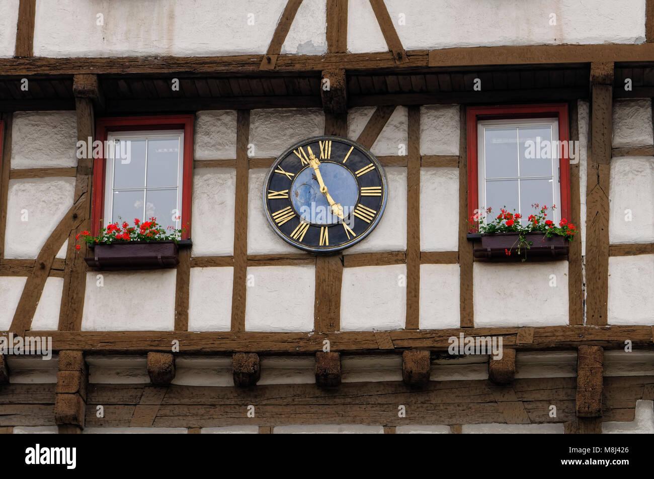 Blaubeuren: Clock at half-timber house in old town, Alb-Donau District, Baden-Württemberg, Germany Stock Photo