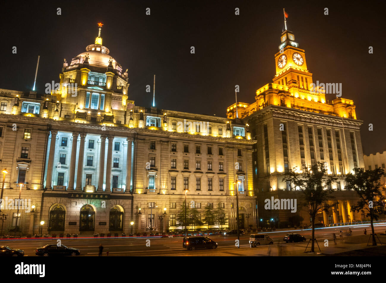 The former Hong Kong & Shanghai Bank and Custom House buildings on Shanghai’s historic Bund seen at night from the waterfront promenade. Stock Photo