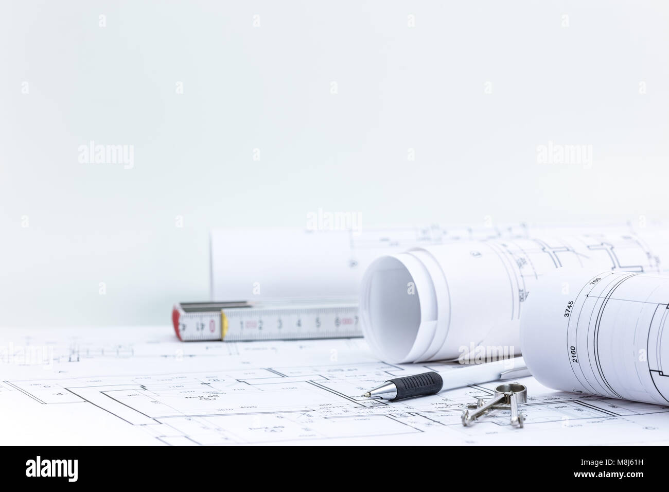 engineering and measuring tools, blueprint rolls with technical plan on architect workplace desk  Stock Photo