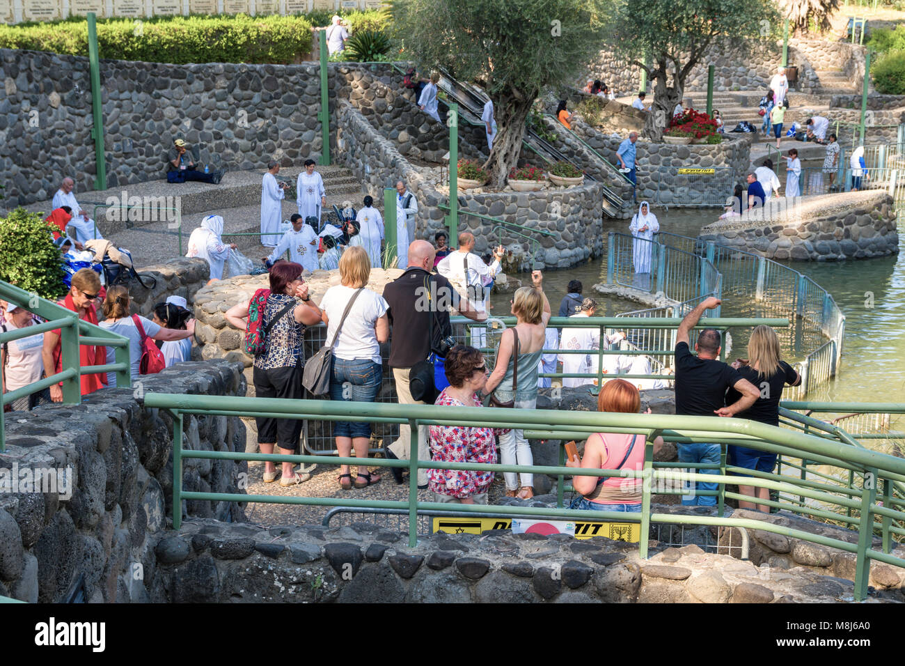 Jordan, Israel - April 21, 2017: Unidentified Christian pilgrims during mass baptism ceremony at the Jordan River in North Israel (Yardenit Baptismal  Stock Photo