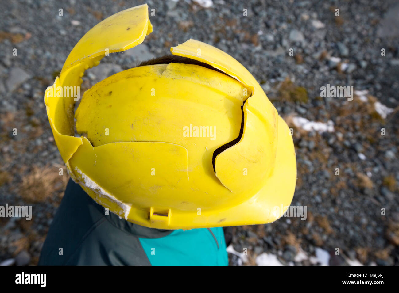 A man wearing a shattered hard hat Stock Photo Alamy