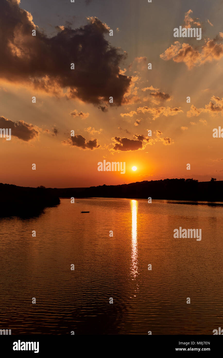 Sunset with clouds and lake on background with tree Stock Photo - Alamy