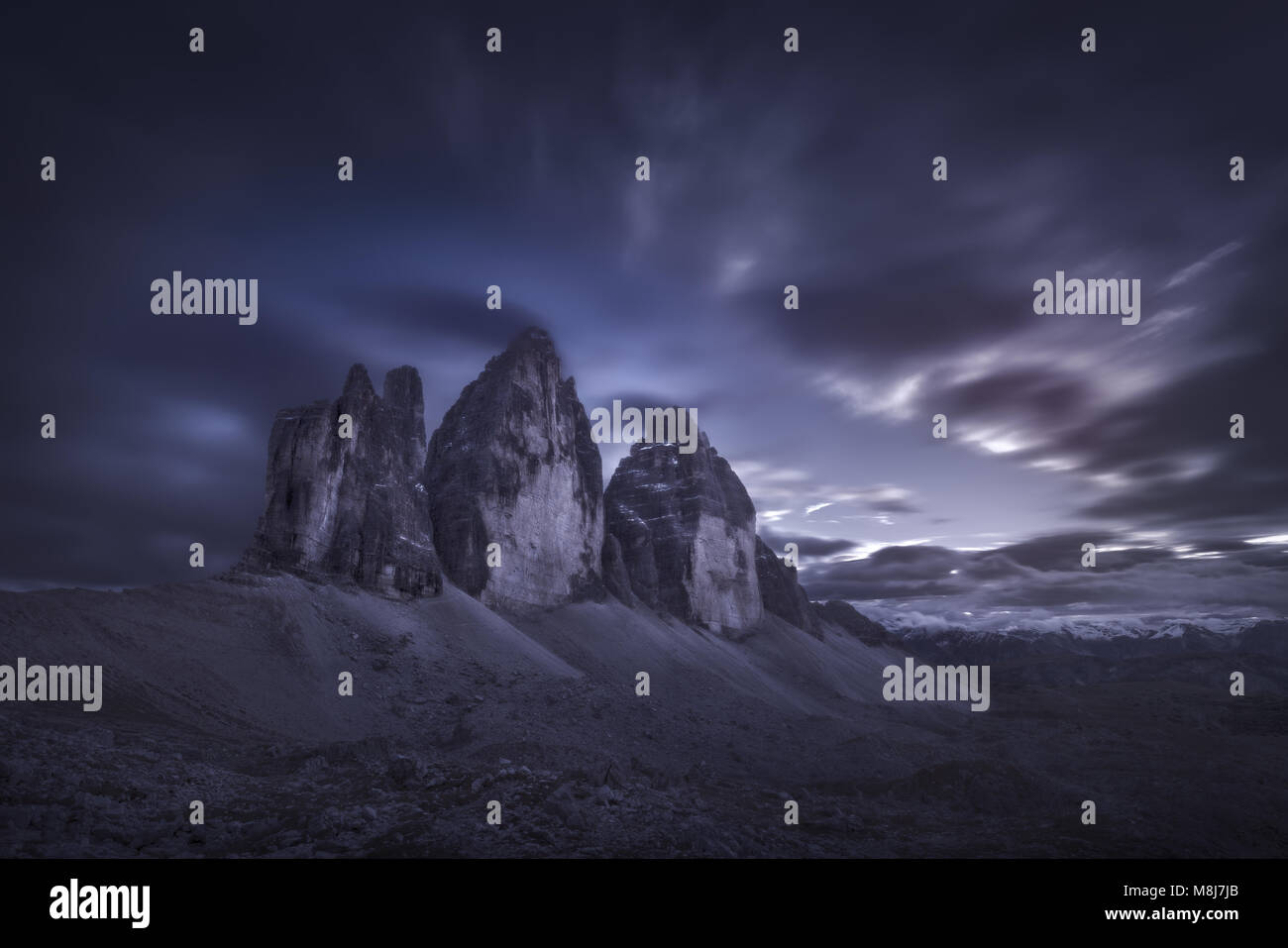 Beautiful moody landscape at dusk of Tre Cime di Lavaredo or Drei Zinnen. Long exposure photo in Dolomites mountain range, Italy. Stock Photo