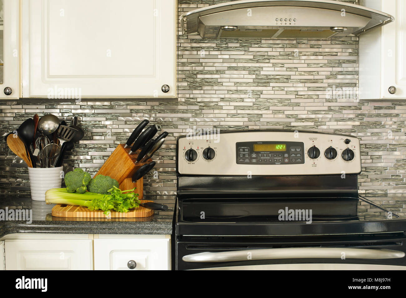 Stainless Steel Stove And Kitchen Utensils On The Cooking Table
