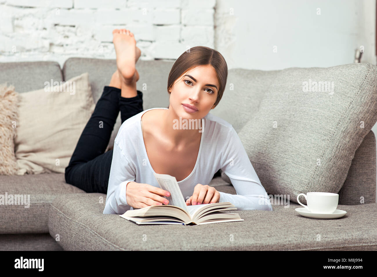 Barefoot girl lying on couch hires stock photography and images Alamy