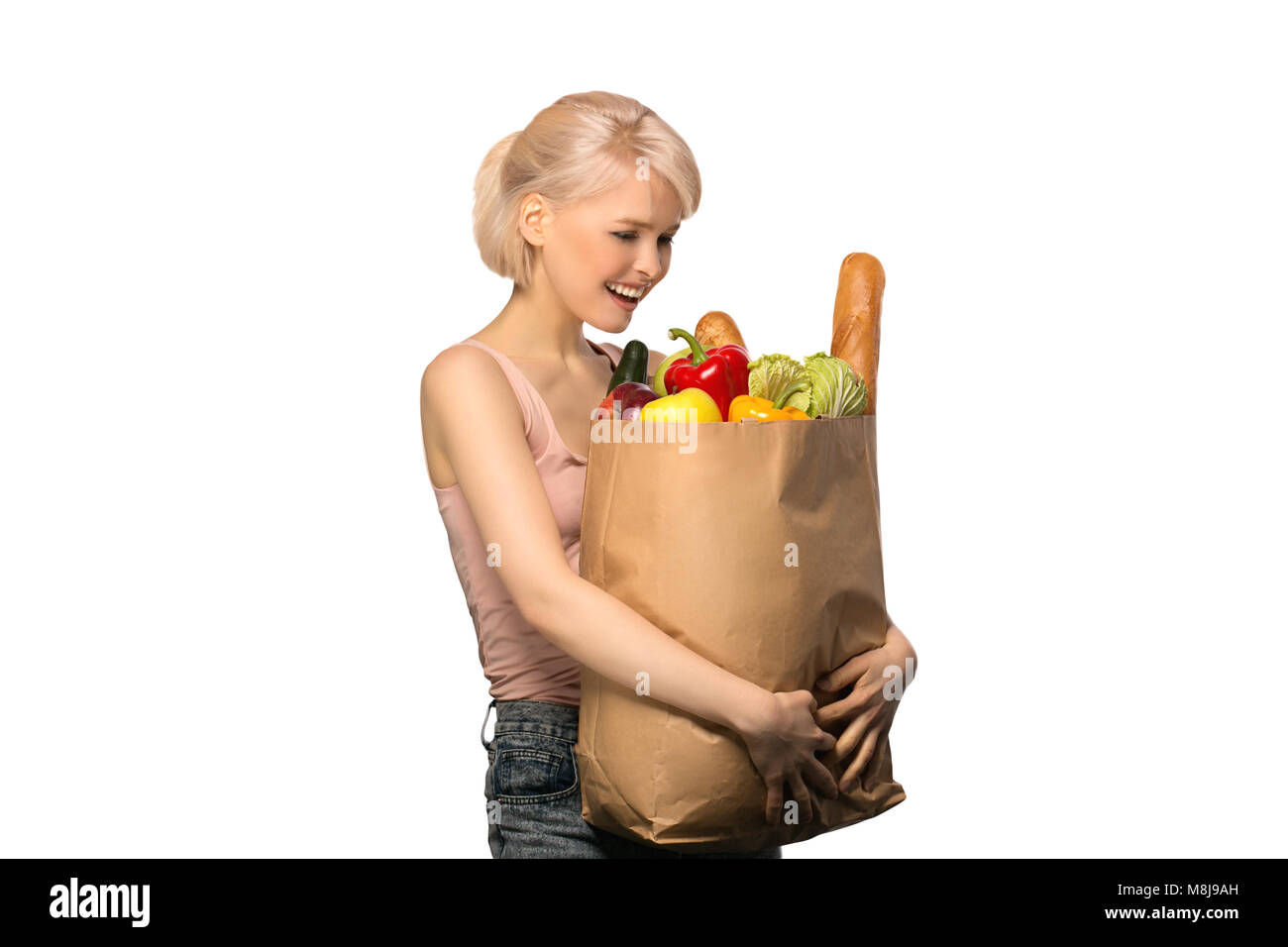 Portrait of happy smiling woman with groceries shopping bag full of vegetables isolated on white background Stock Photo