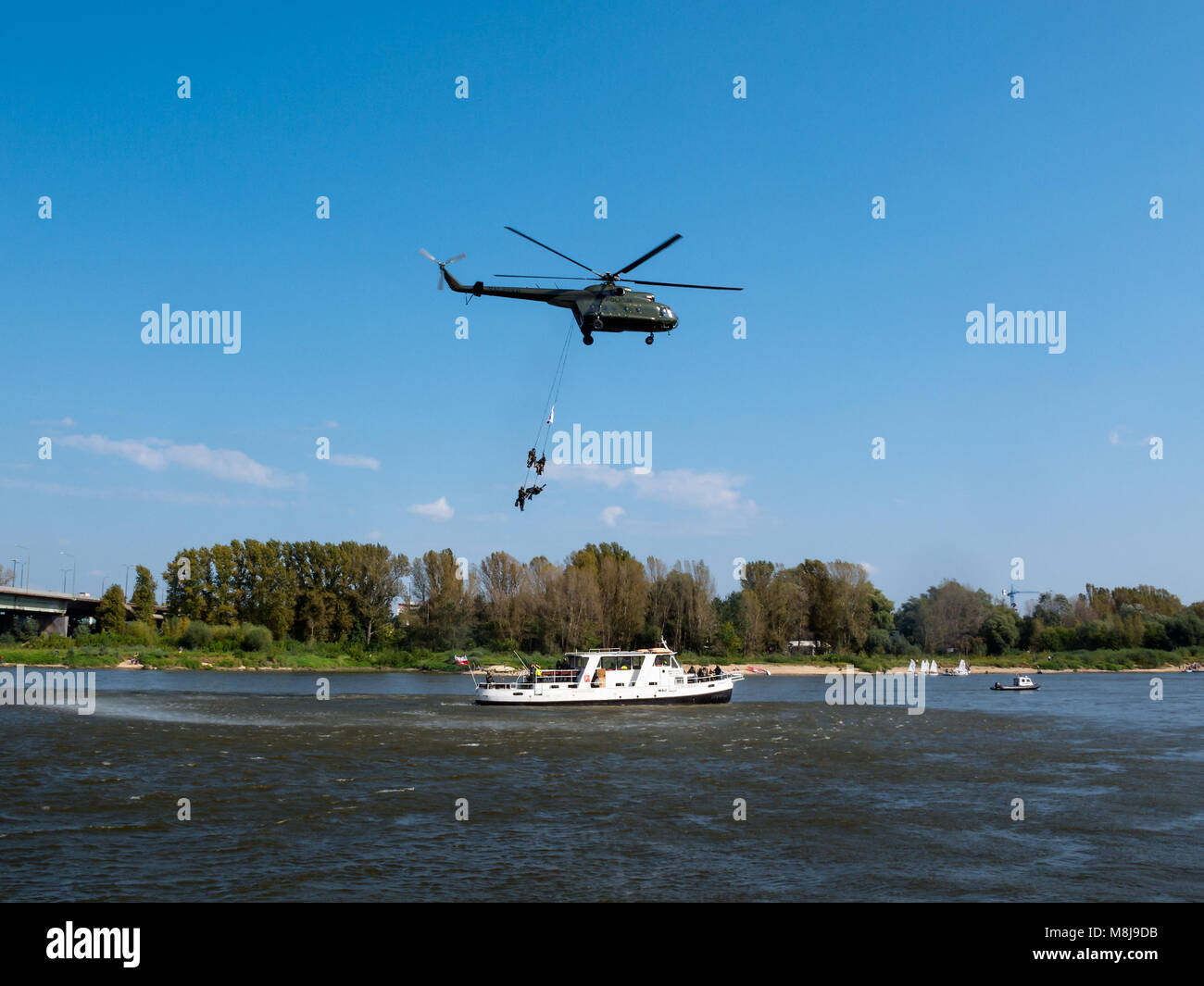 WARSAW, POLAND - SEPTEMBER 13, 2014: Polish GROM Special Forces show boarding a boat with terrorists from a helicopter. Stock Photo