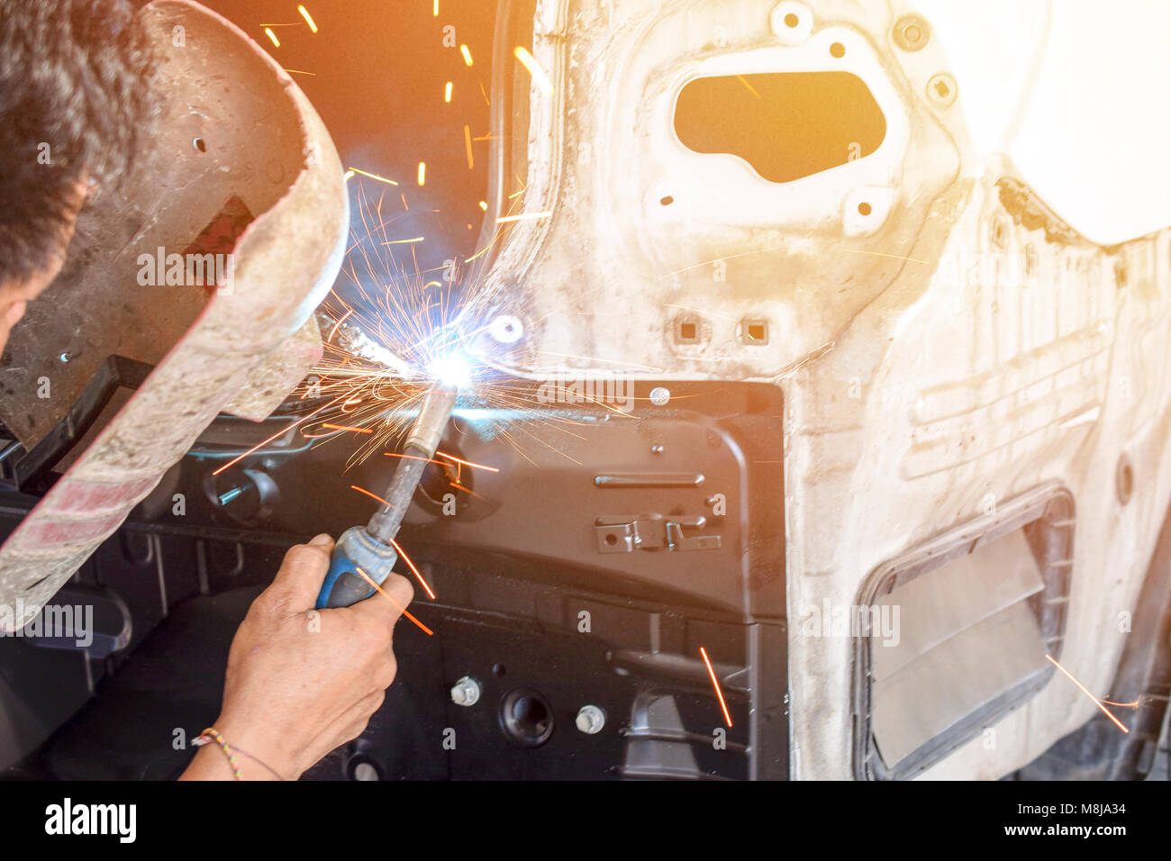 Men welder automotive part - auto body repair shop Stock Photo