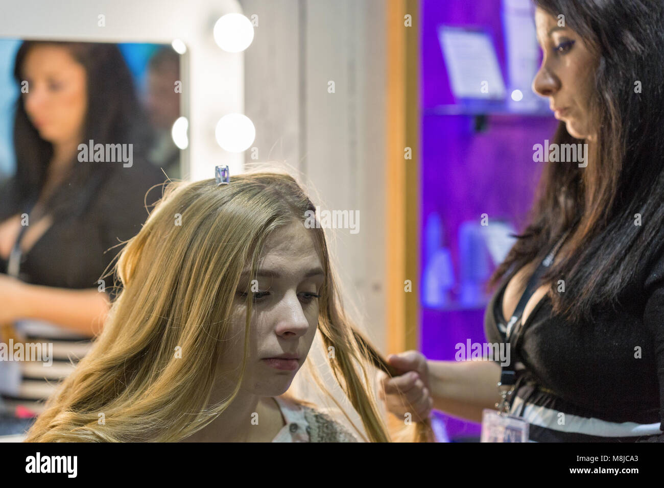 KIEV, UKRAINE OCTOBER 08, 2017 Hairdresser makes hairstyle on