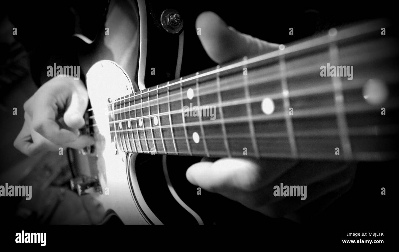 Black & white close up of an electric guitar being played Stock Photo