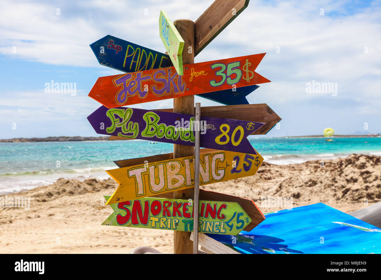 ORIENT BAY BEACH, ST.MAARTEN -  AUGUST 02: Sign with pricing for rental and services on famous Orient Bay Beach. Stock Photo