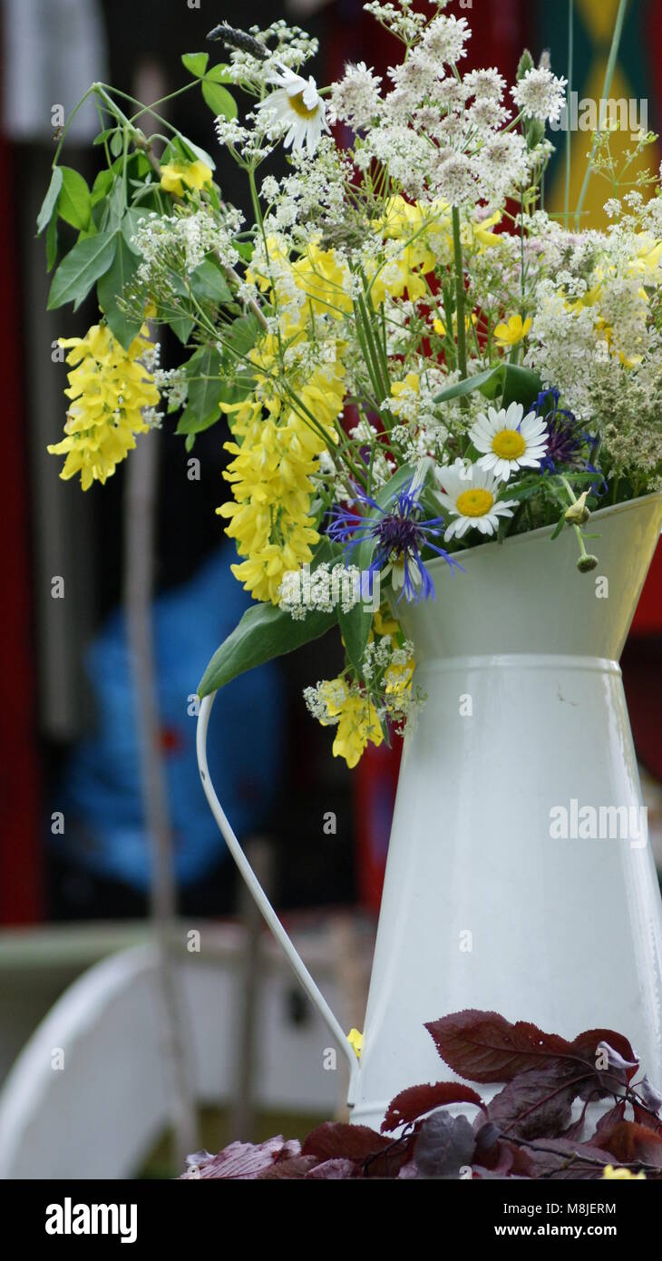 Bunch of wildflowers in an enamel milk jug Stock Photo Alamy