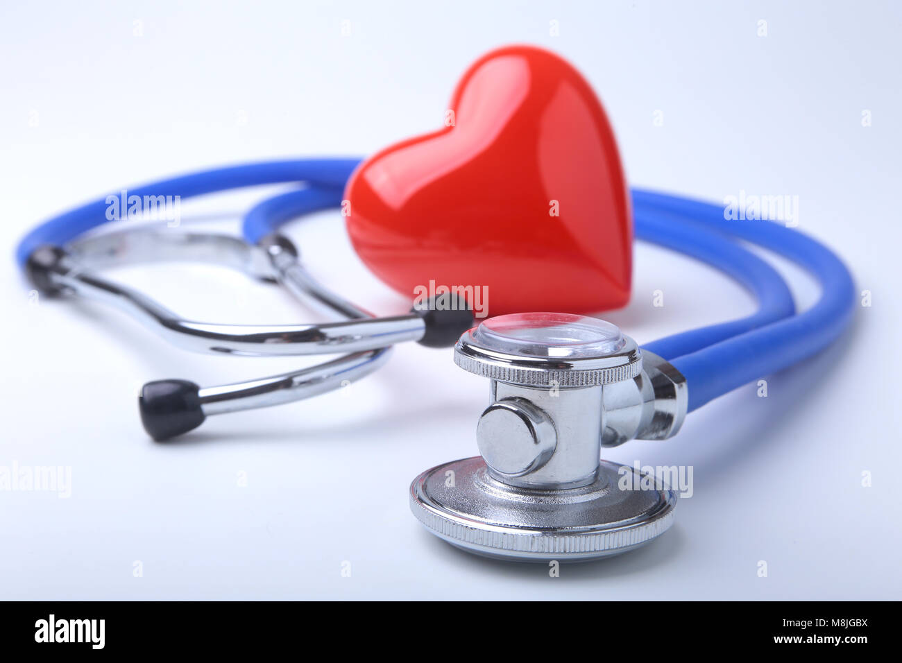 Red heart and a stethoscope on white background Stock Photo - Alamy