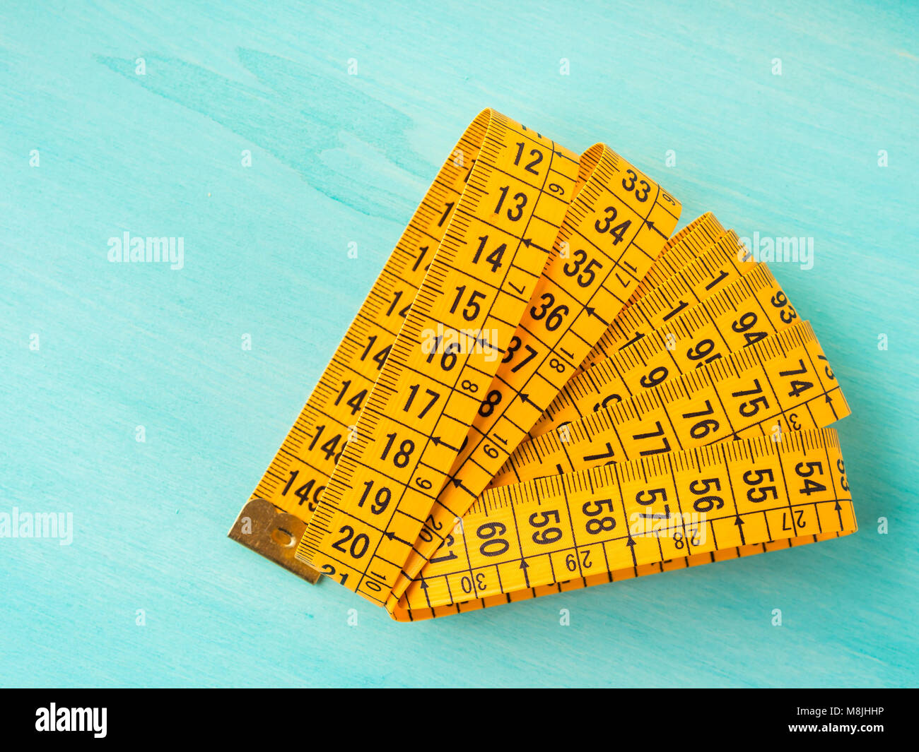 Measuring meter on green pastel background Stock Photo - Alamy