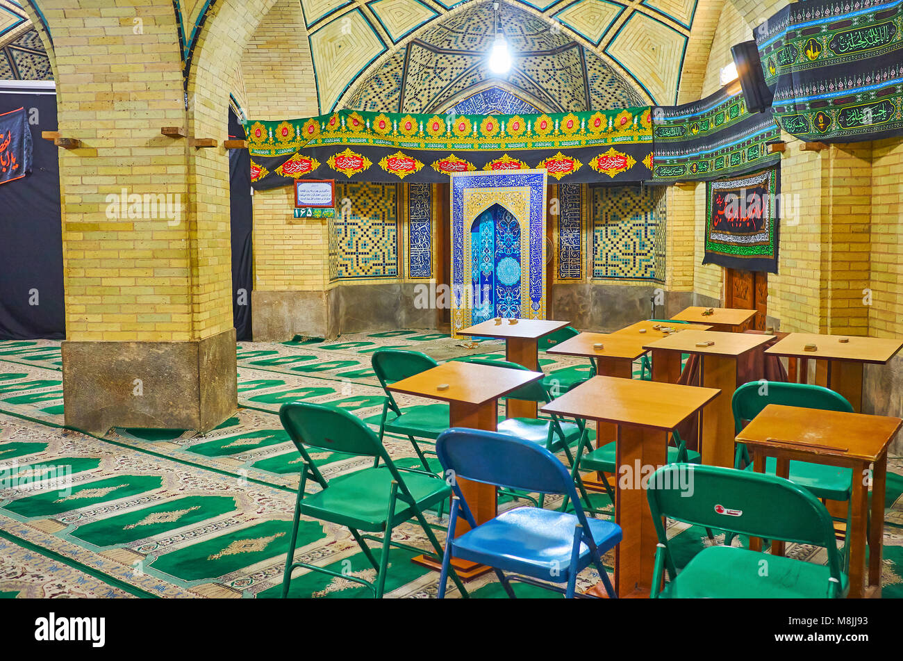 ISFAHAN, IRAN - OCTOBER 20, 2017: The classroom in Chaharbagh madraseh with desks and chairs in building of the mosque, on October 20 in Isfahan. Stock Photo