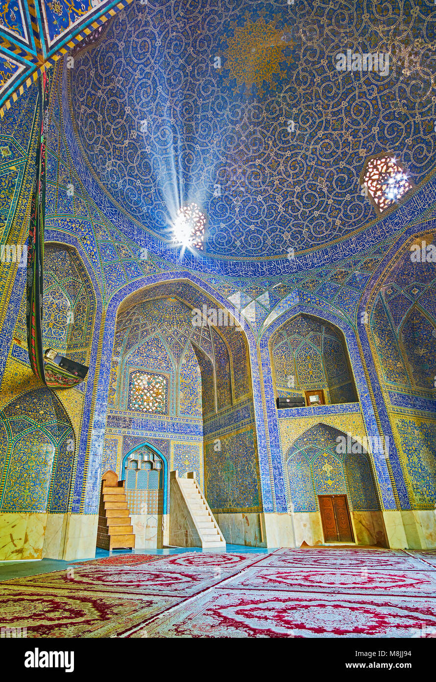 ISFAHAN, IRAN - OCTOBER 20, 2017: Interior of mosque of Chaharbagh madraseh, walls and dome decorated with beautiful ornaments of glazed tiles, on Oct Stock Photo