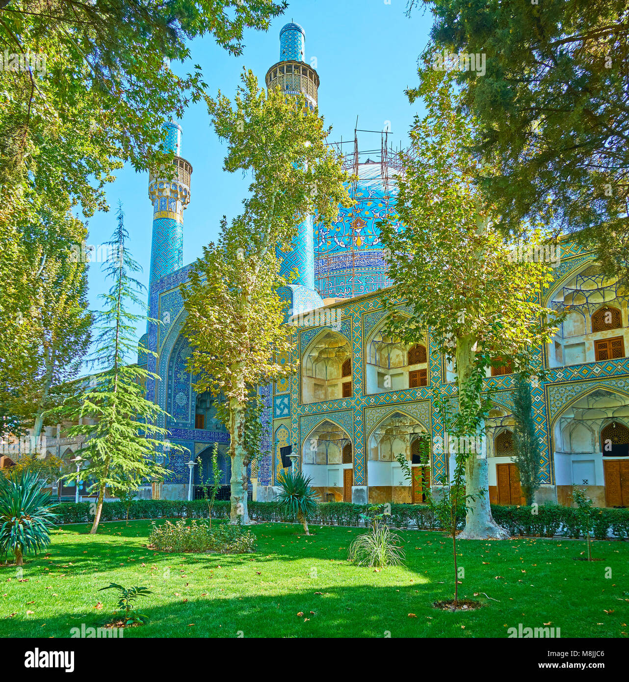The view on medieval mosque of Chaharbagh madraseh, hidden in lush ...