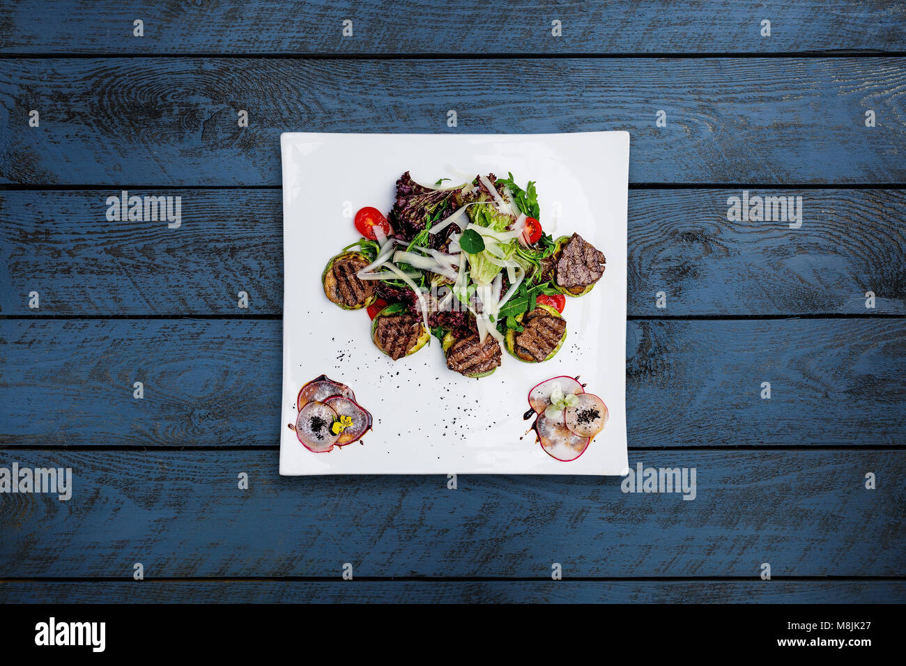Warm salad with grilled veal, mix vegetables and apple sauce. Stock Photo