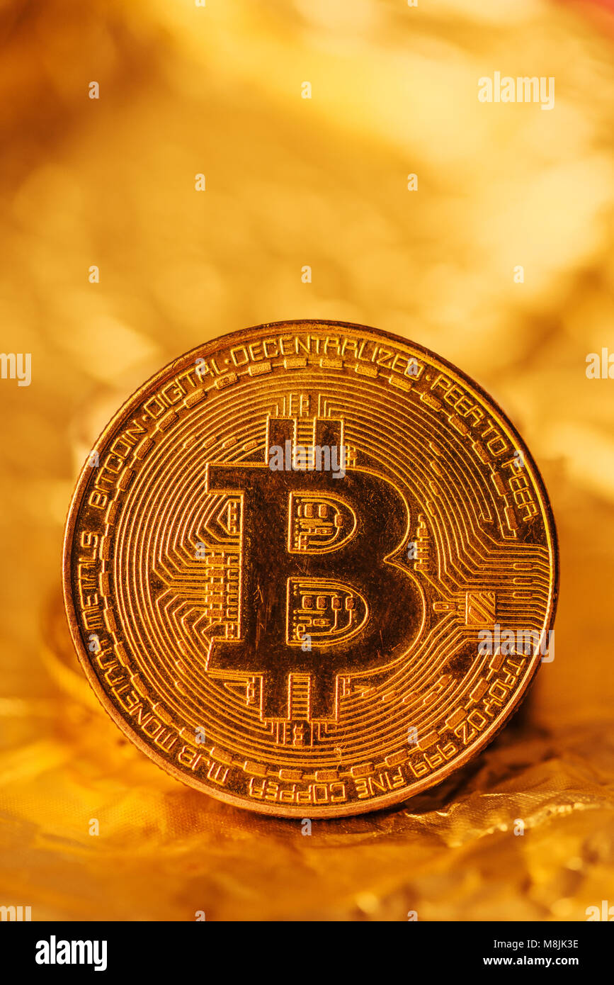 Bitcoin, blockchain cryptocurrency golden coin on gold metal background to  emphasize the value of virtual currency in modern world Stock Photo - Alamy