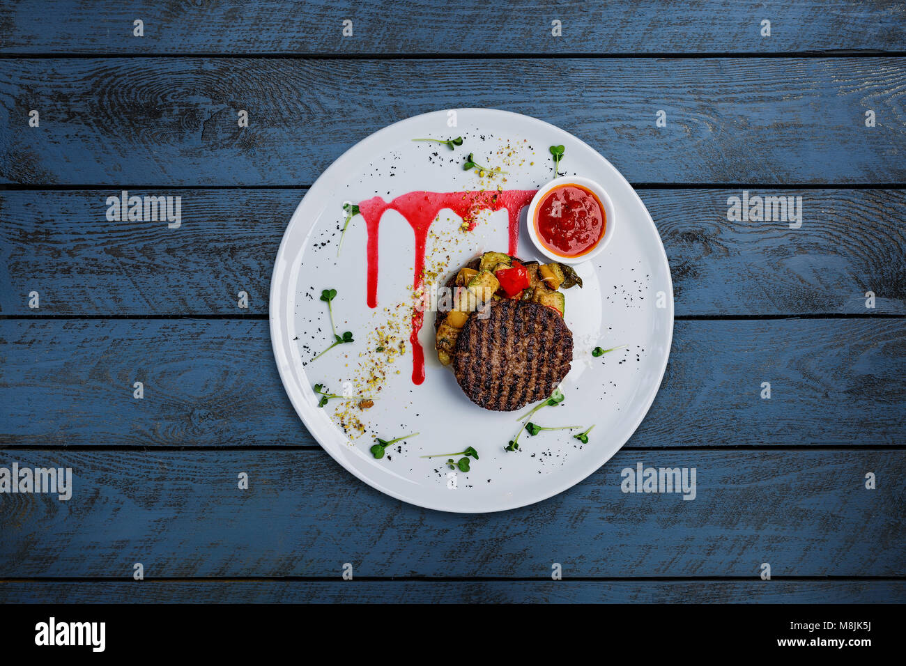 Grilled cutlets from veal with grilled mix vegetables and sauce. Stock Photo
