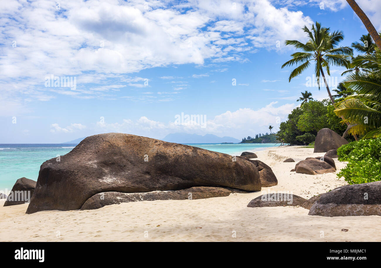 Paradise island in the Seychelles, sandy beach and blue sky over Indian Ocean Stock Photo