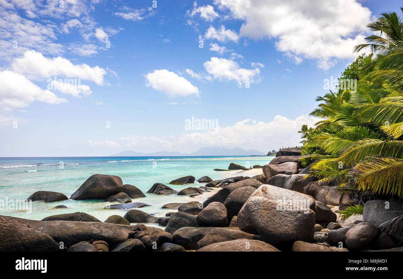 Paradise island in the Seychelles, sandy beach and blue sky over Indian Ocean Stock Photo