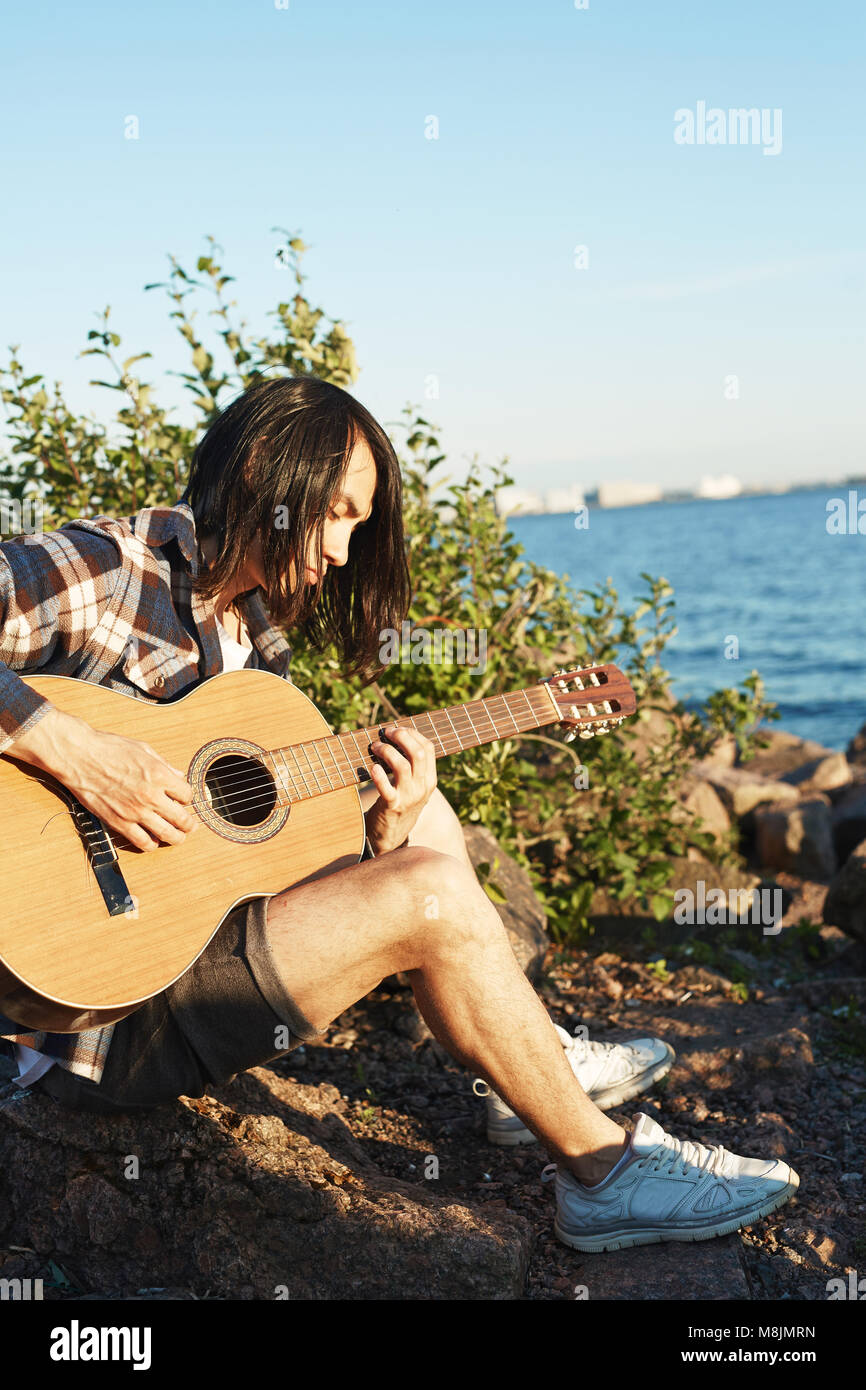 Guy by water Stock Photo