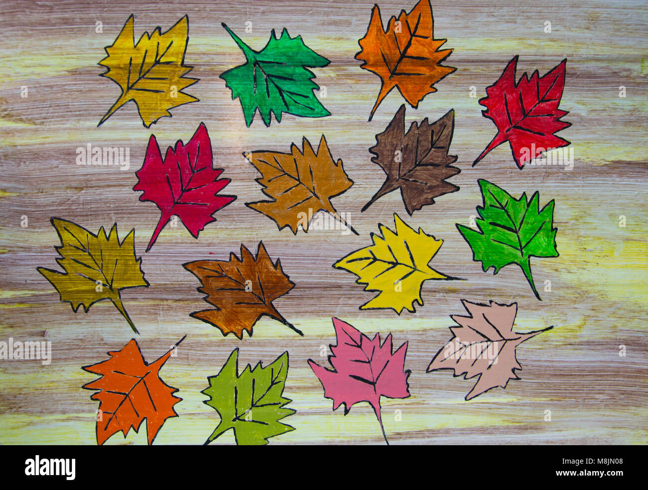 Hand painted autumn leaves on colour wash wood panel background Stock Photo