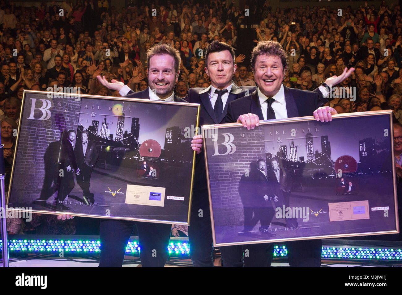 L-R: Alfie Boe, Rick Astley, Michael Ball. Rick Astley presents Michael Ball and Alfie Boe with a golden disc live on stage during their performance at the Eventim Apollo, Hammersmith. Michael Ball and Alfie Boe's album ‘Together’ went gold in just 15 days. Stock Photo
