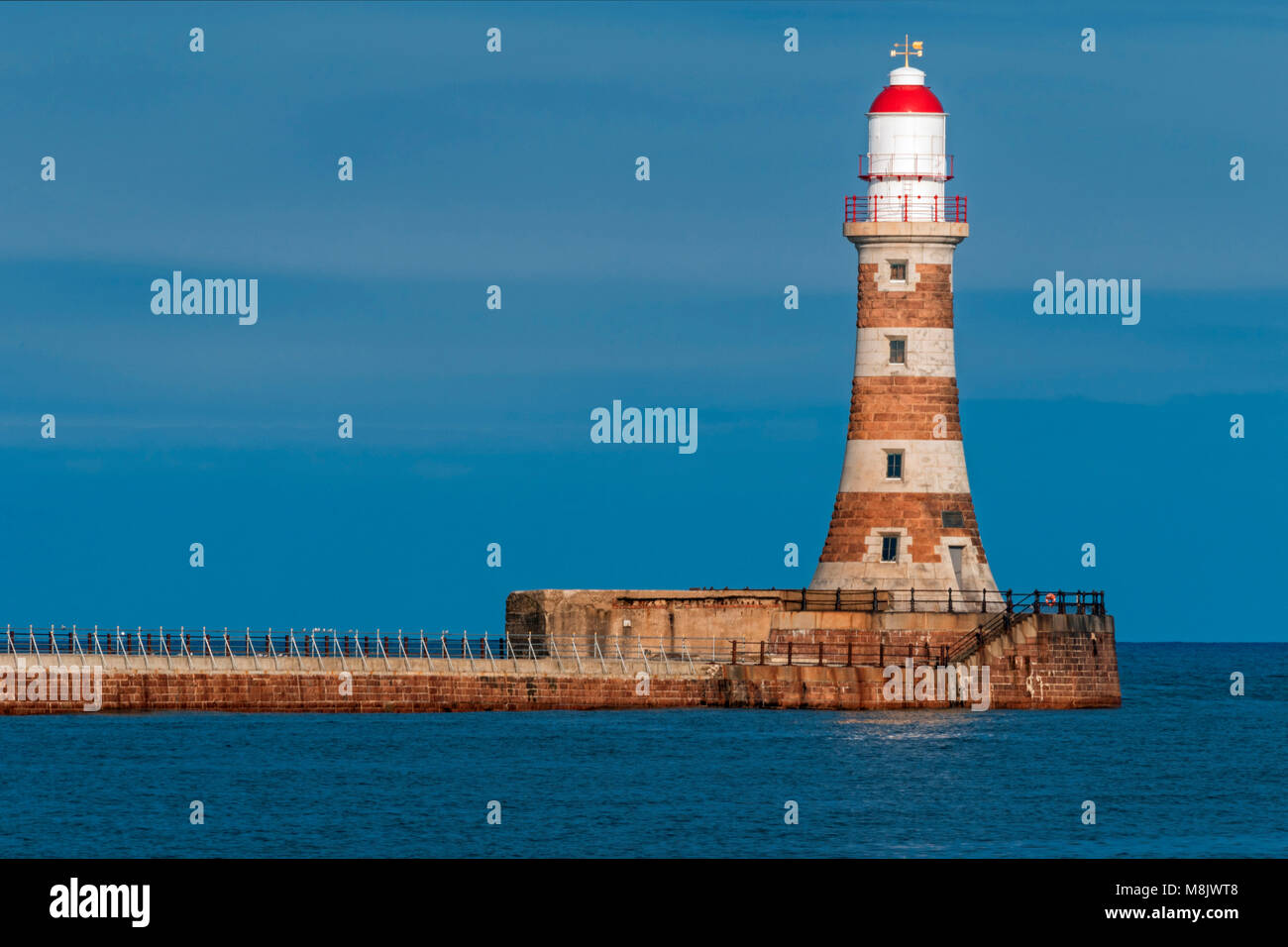 Roker Lighthouse on Roker Pier with blue sky and sea Stock Photo - Alamy