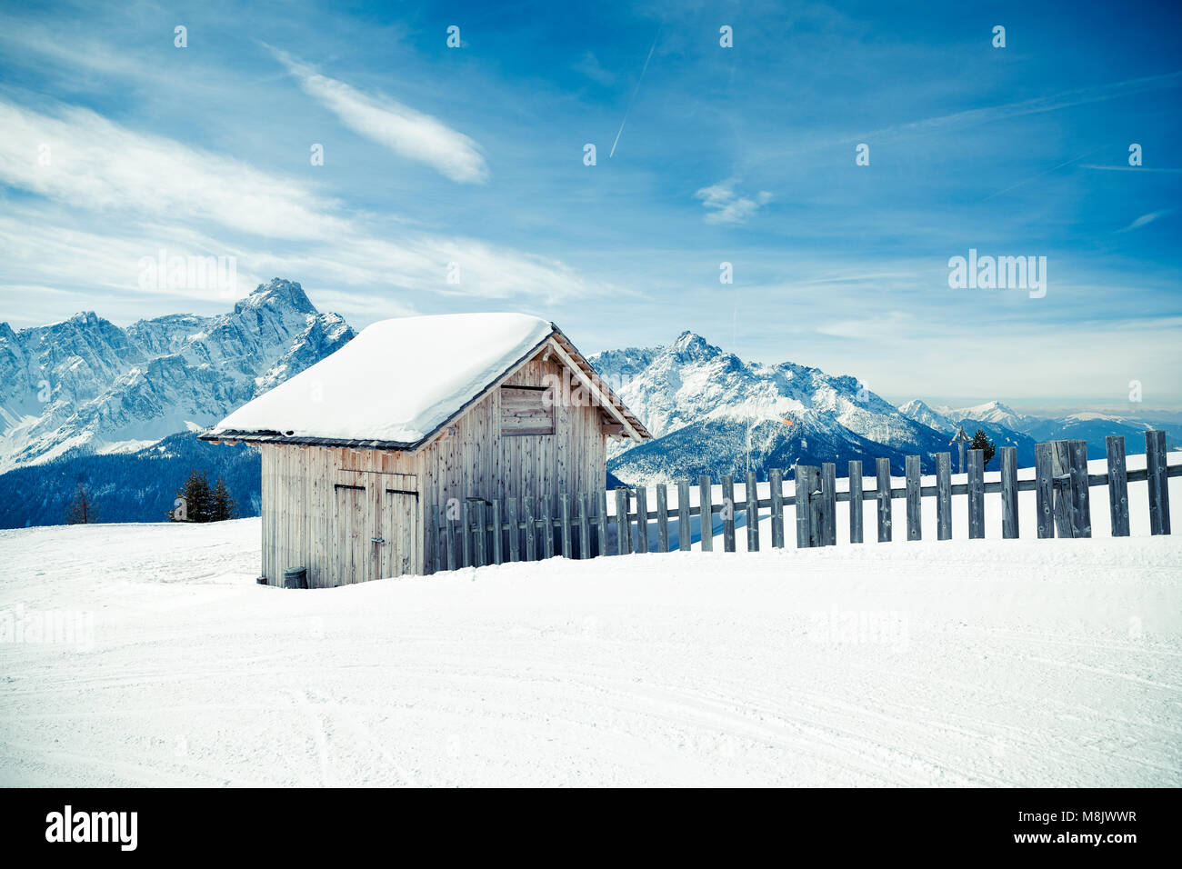 Little cottage covered with snow in the high Dolomites mountains, winter landscape. Mont'Elmo, San Candido, Italy Stock Photo