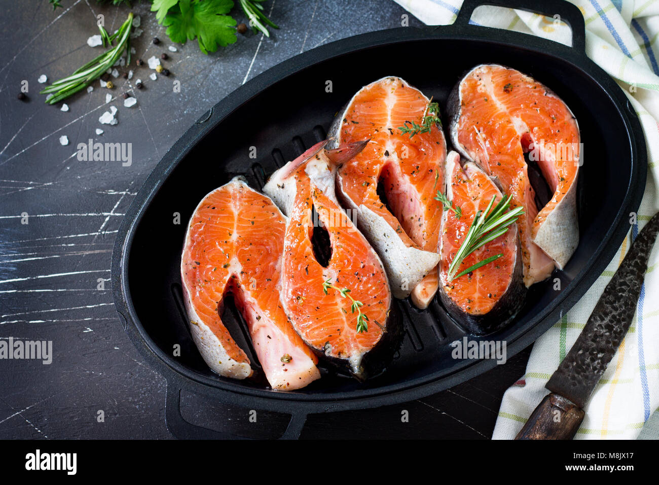 Fresh salmon pickled for a barbecue on a castiron frying pan. Proper
