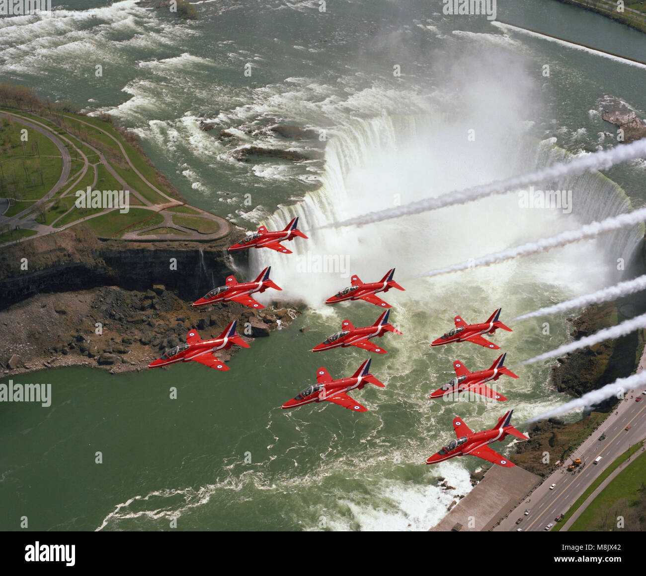 The Red Arrows  ( the Aerobatic display team of the Royal Air Force), overflying Niagara Falls, Canada Stock Photo