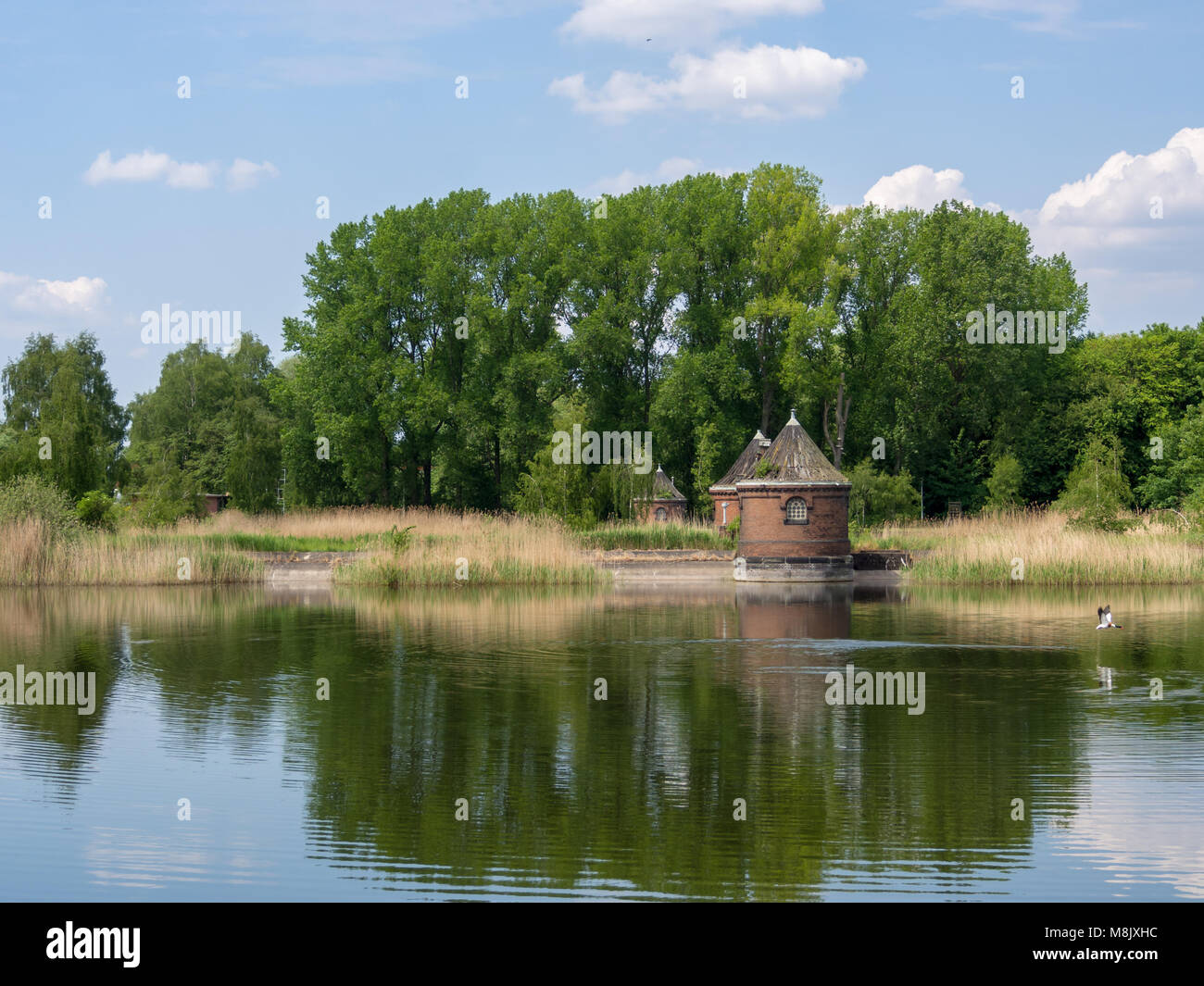 Hamburg, Germany - May 19, 2016: Decayed control cabin at pond of the site of industrial museum Wasserkunst Kaltehofe, a former water treatment plant. Stock Photo