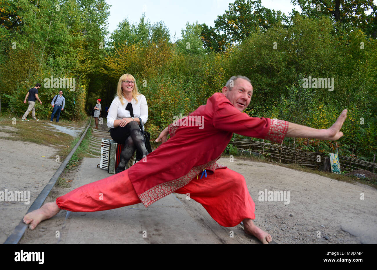 A man in folk dress, entertaining visitors near the Tunnel of Love, near Rivne, Ukraine Stock Photo