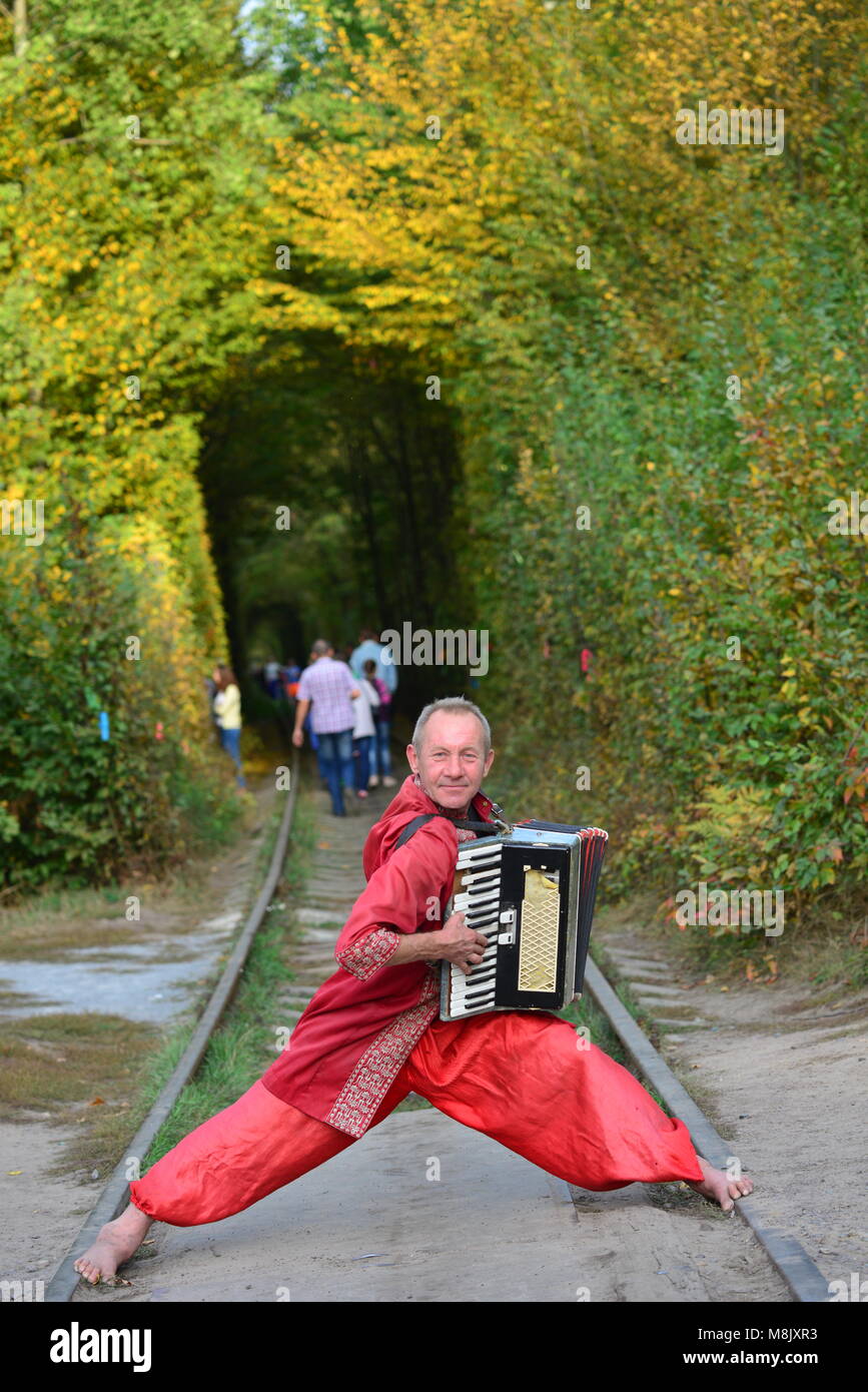 An accordion player, entertaining visitors to the Tunnel of Love, near Rivne, Ukraine Stock Photo
