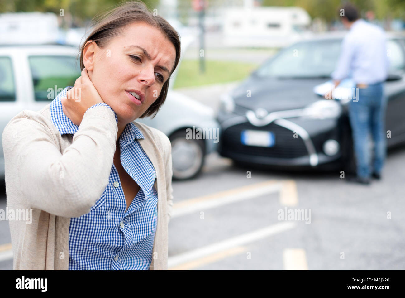 Woman feeling pain after car accident in the city Stock Photo Alamy