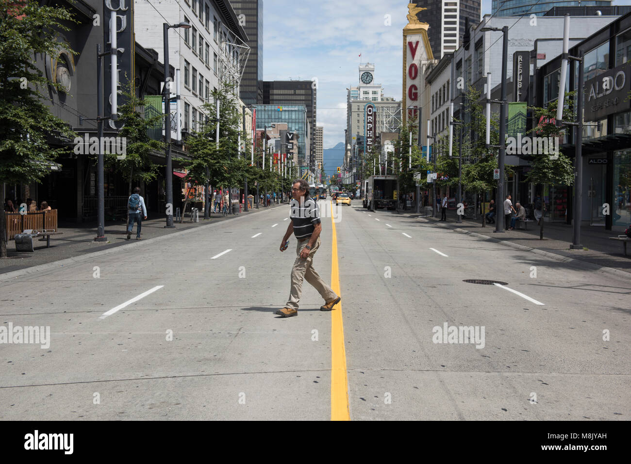 Man jaywalking across Granville Street, Vancouver City. Stock Photo