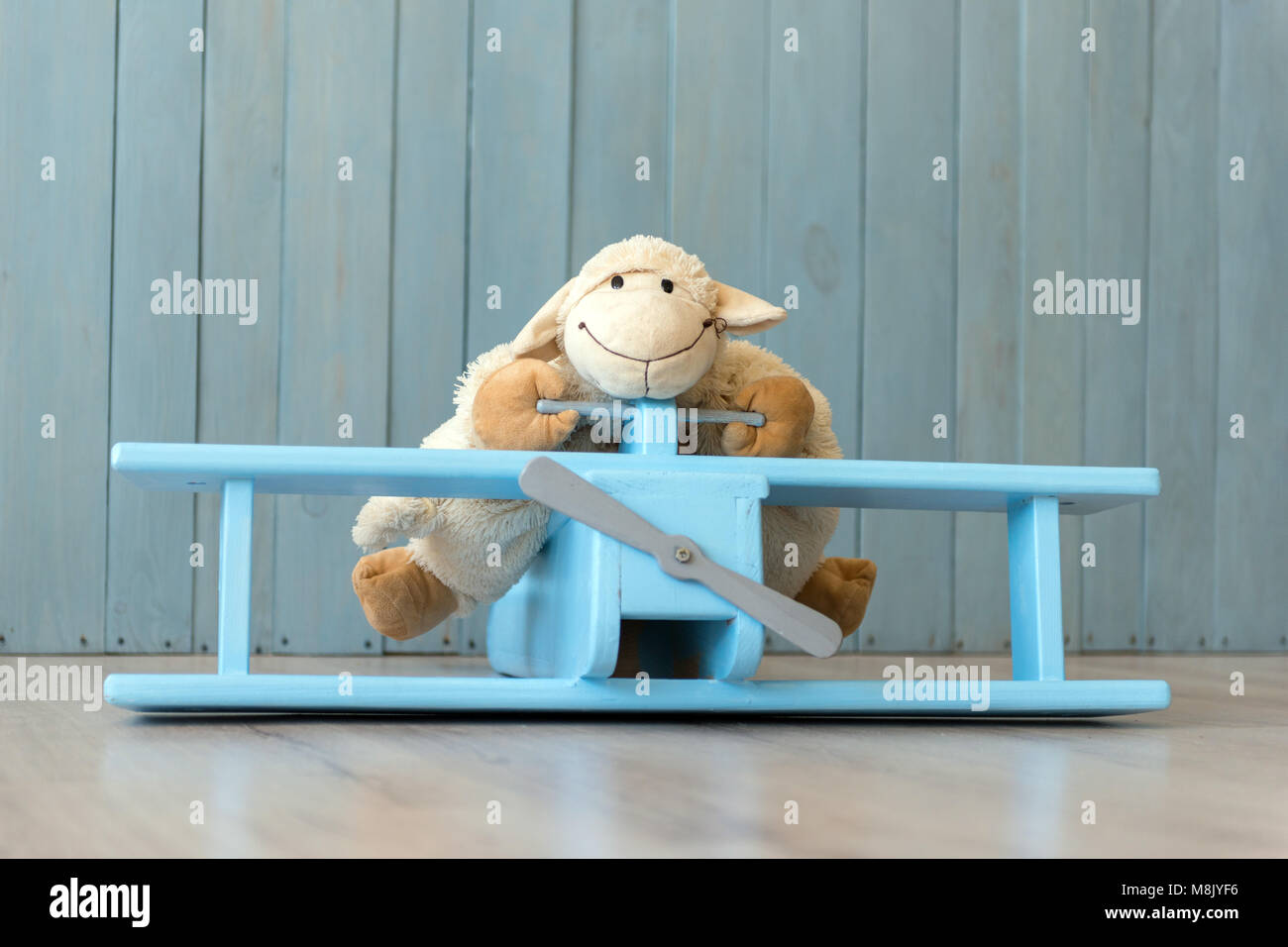 Wooden retro airplane model and sheep toy over retro vintage brown background. Toys from wood Stock Photo