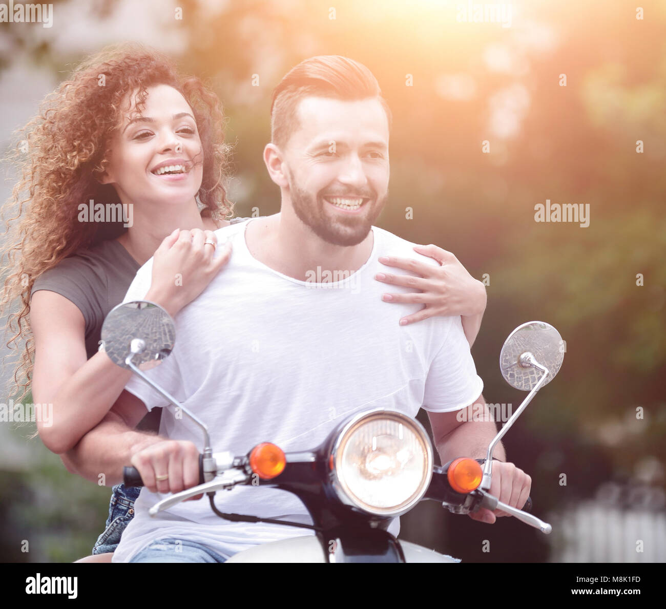 Happy smiling and screaming male tourist in helmet and sunglasses riding motorbike  scooter during his tropical vacation under palm trees Stock Photo - Alamy