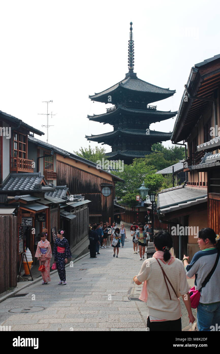 Visitors and tourists walk at the traditional Kyoto street at well-known Gion, Higashiyama District. Yasaka Shrine in the background. Stock Photo